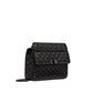 Black quilted handbag with chain detail on a light gray background