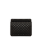 Black quilted handbag with studs on a light gray background
