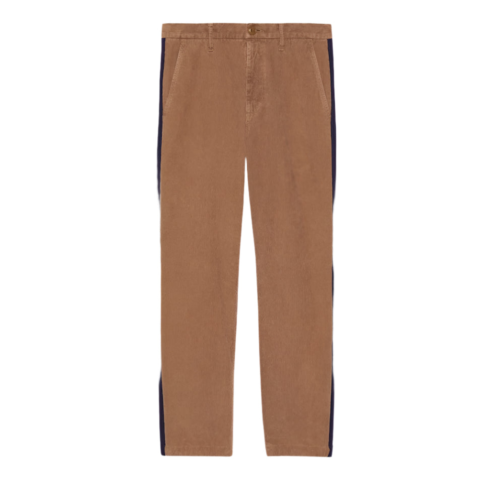 Brown Gucci pants with black side stripes on a light gray background