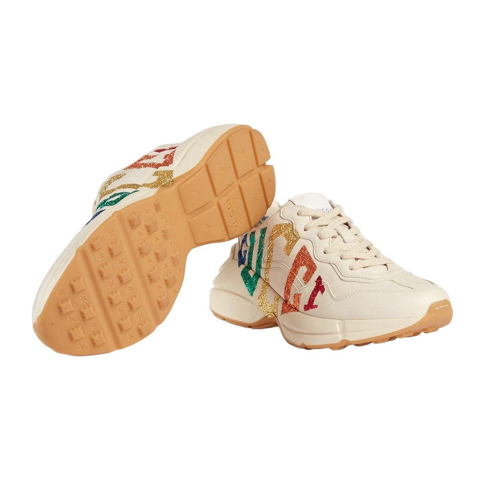 Beige sneakers with colorful text on a light gray background