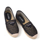 Black espadrille shoes with Prada logo on a white background