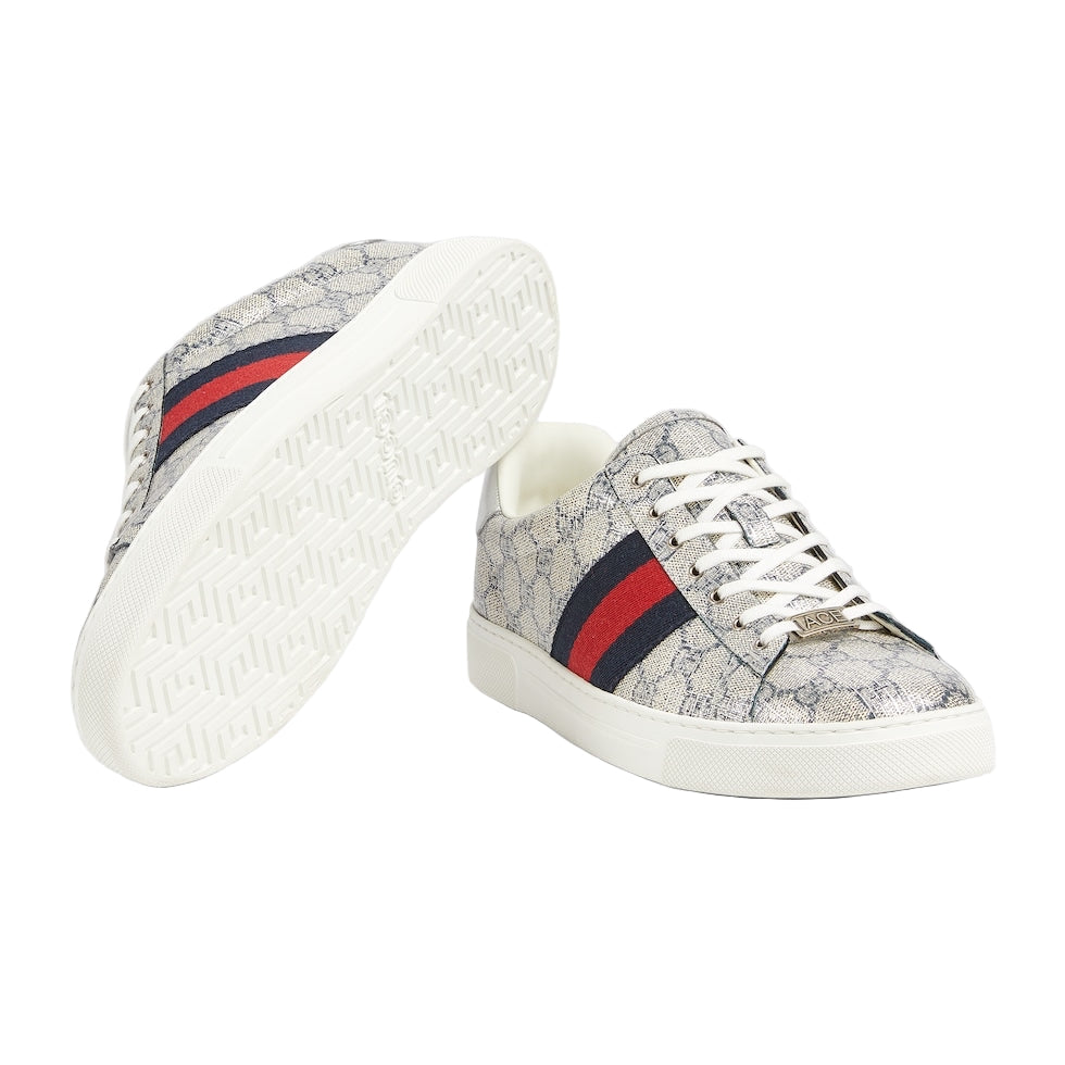 Pair of sneakers with a patterned design and red and blue stripes on a light gray background