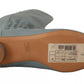 Gray shoe with a brown sole on a white background