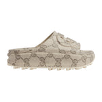 Beige slip-on shoes with a pattern on a light gray background