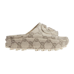 Beige slip-on shoes with a pattern on a light gray background