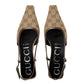 Pair of Gucci high heels on a light gray background