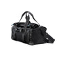 Black duffel bag with straps on a light gray background