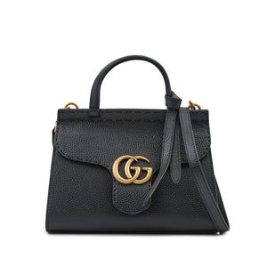 Black handbag with gold logo on a white background