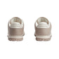 Pair of beige sneakers on a light gray background