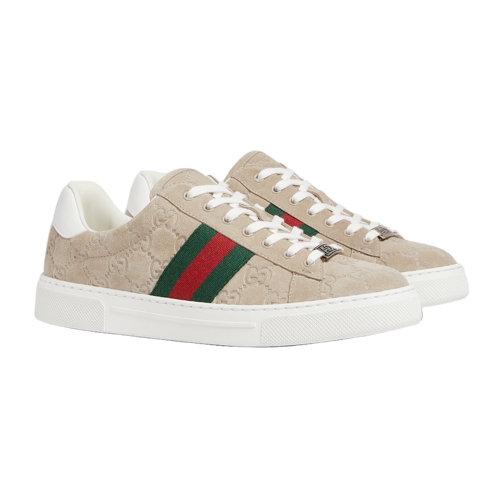 Beige Gucci sneakers with green and red stripes on a light gray background