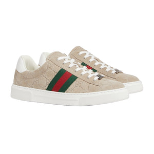 Beige Gucci sneakers with green and red stripes on a light gray background