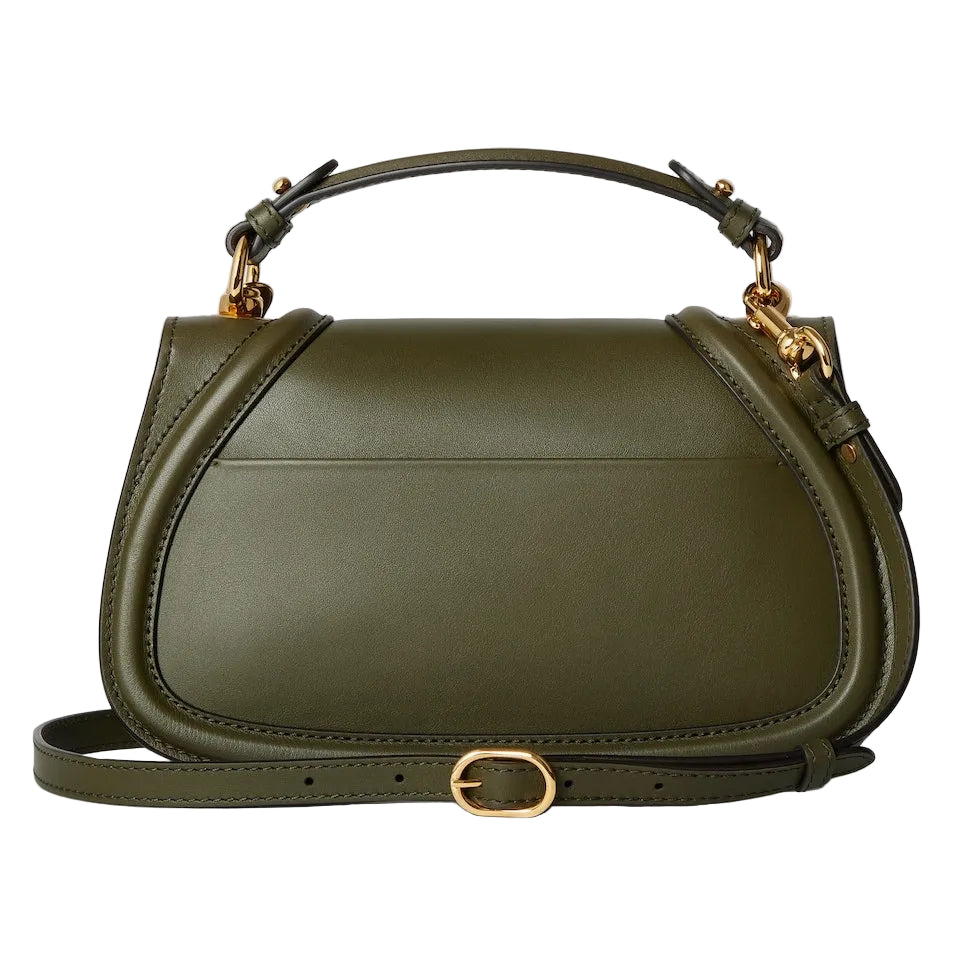 Green handbag with gold accents on a light gray background