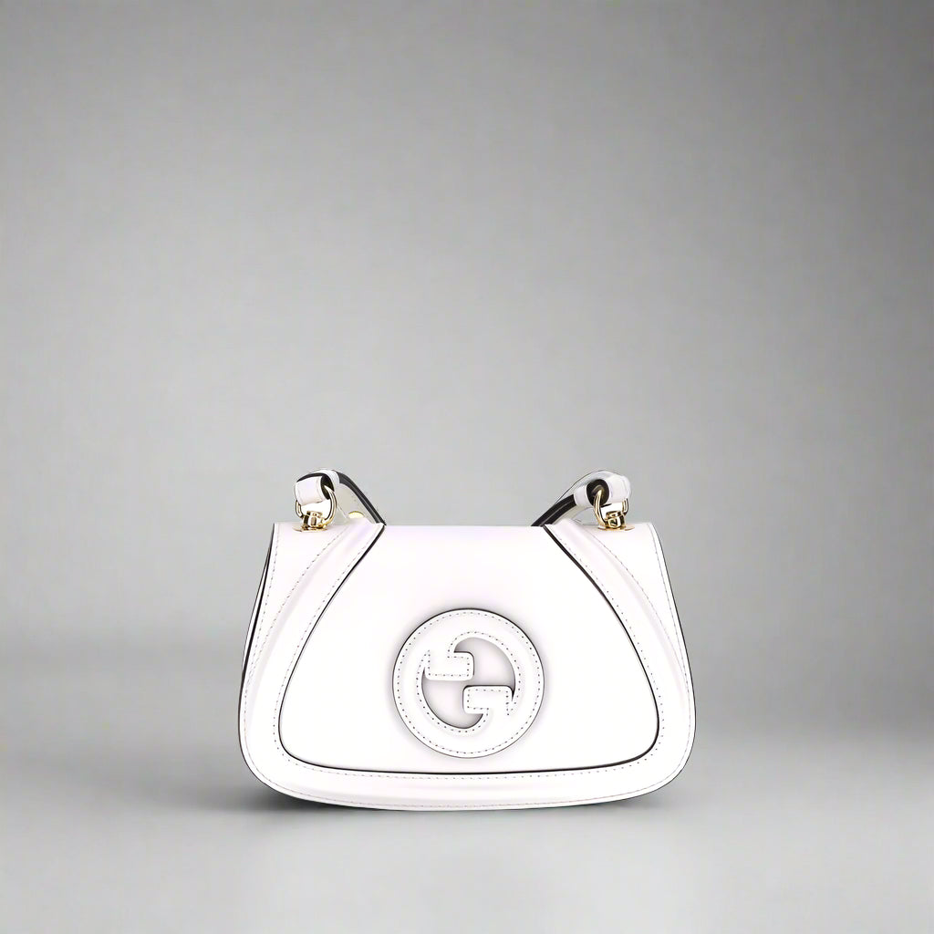 White handbag with a circular logo on a white background