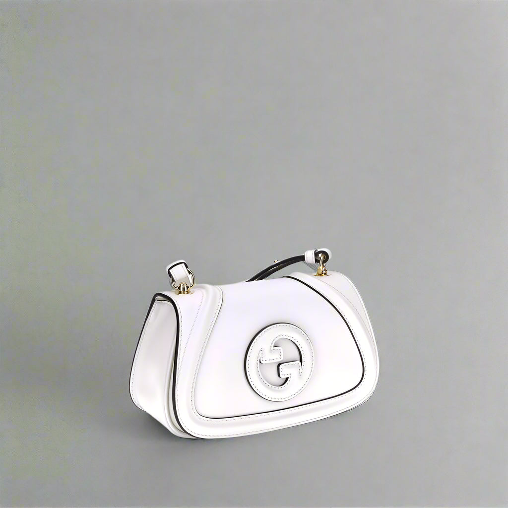 White handbag with a brand logo on a white background