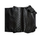 Black leather bag with geometric pattern on a light gray background