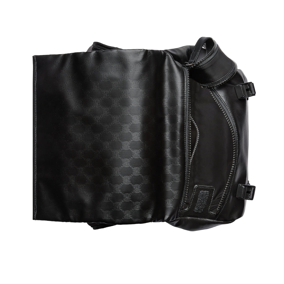 Black leather bag with geometric pattern on a light gray background