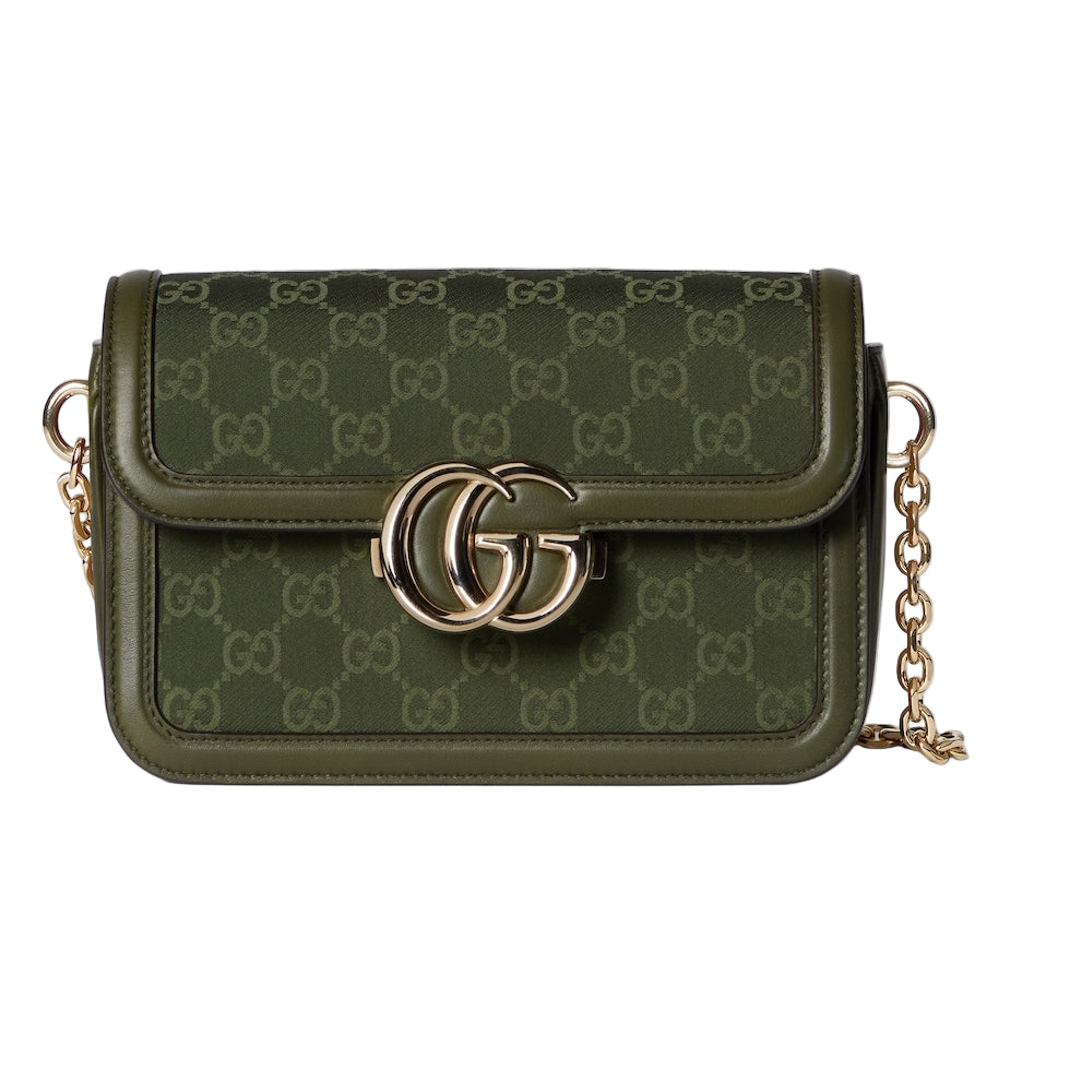 Green handbag with gold chain and logo on a light gray background