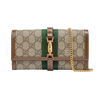 Designer handbag with chain strap on a light gray background