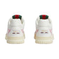 White sneakers with Gucci logo on a light gray background