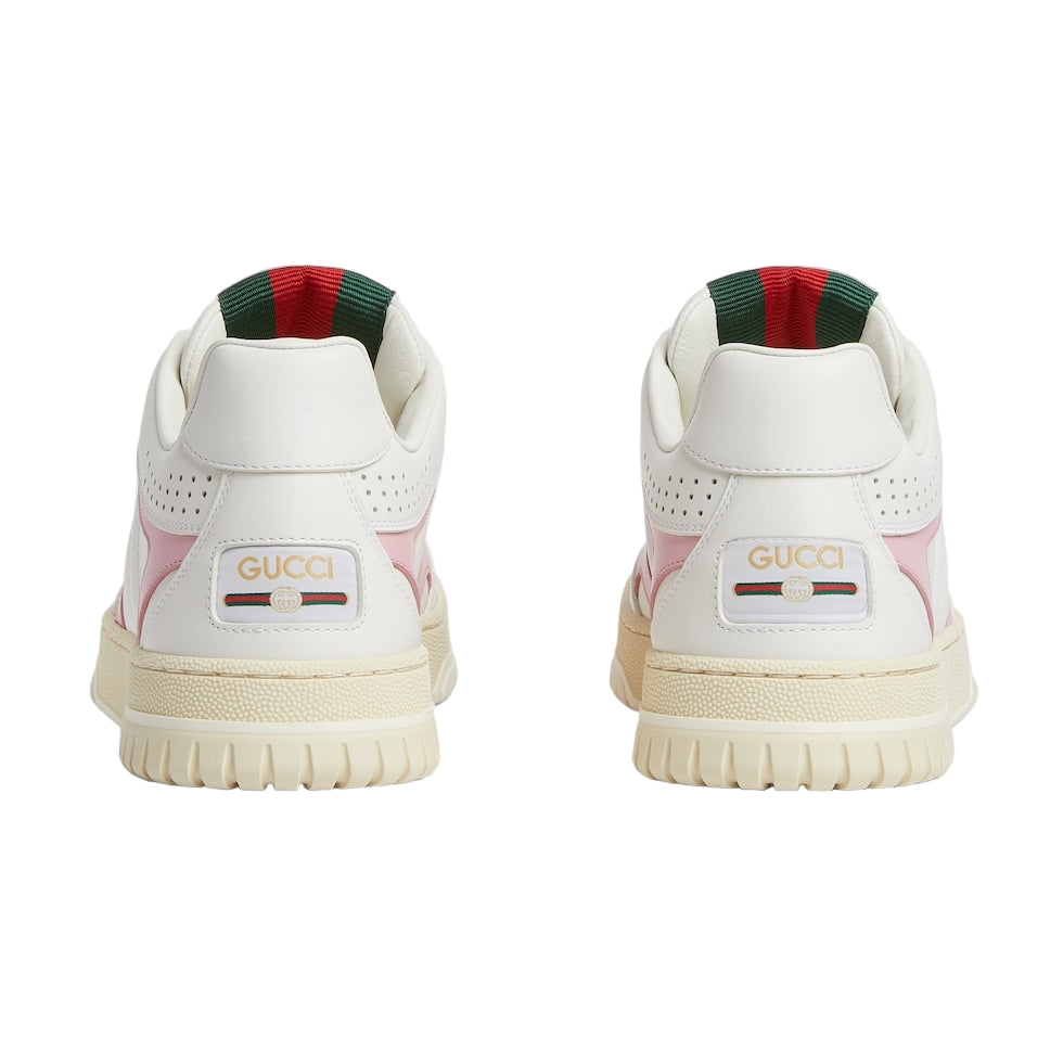 White sneakers with Gucci logo on a light gray background