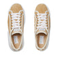 Pair of Gucci sneakers with tan suede upper and white laces on a light gray background