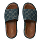 Pair of Gucci slides with blue patterned uppers and brown soles on a white background