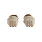 Pair of beige loafers with textured sole on a light gray background