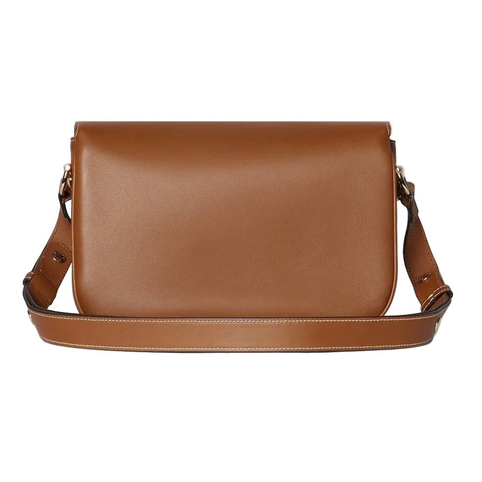 Brown leather shoulder bag on a light gray background