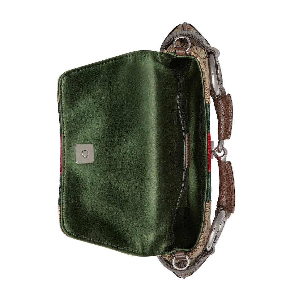 Green bag with brown leather strap on a light gray background