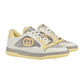 Pair of sneakers with a mix of gray, yellow, and white on a light gray background