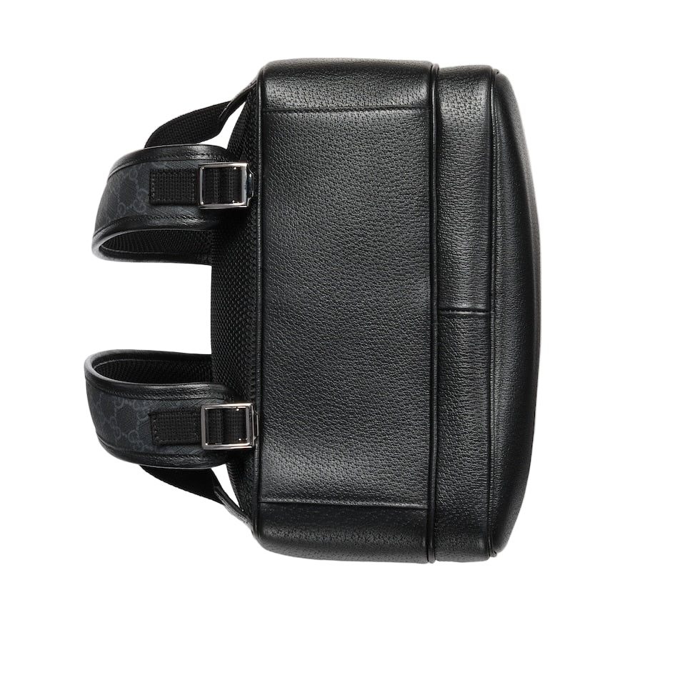 Black leather backpack on a light gray background