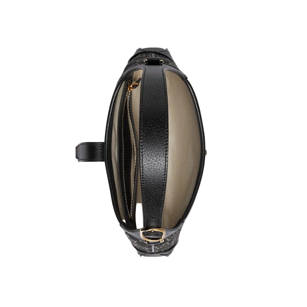 Black and beige leather bag with zipper on a light gray background