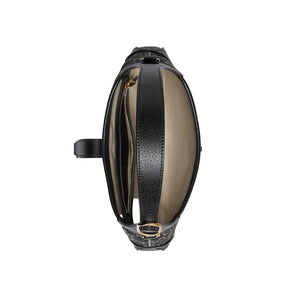 Black and beige leather bag with zipper on a light gray background