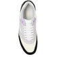 White sneaker with black sole and purple accents on a white background