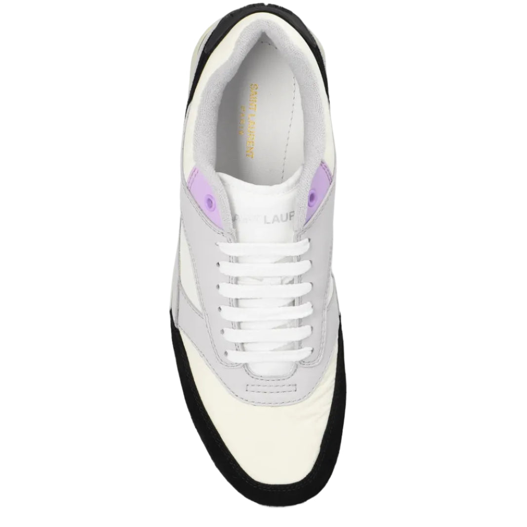 White sneaker with black sole and purple accents on a white background