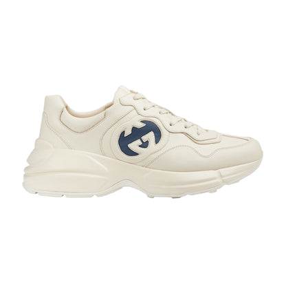 White sneaker with a blue logo on a light gray background