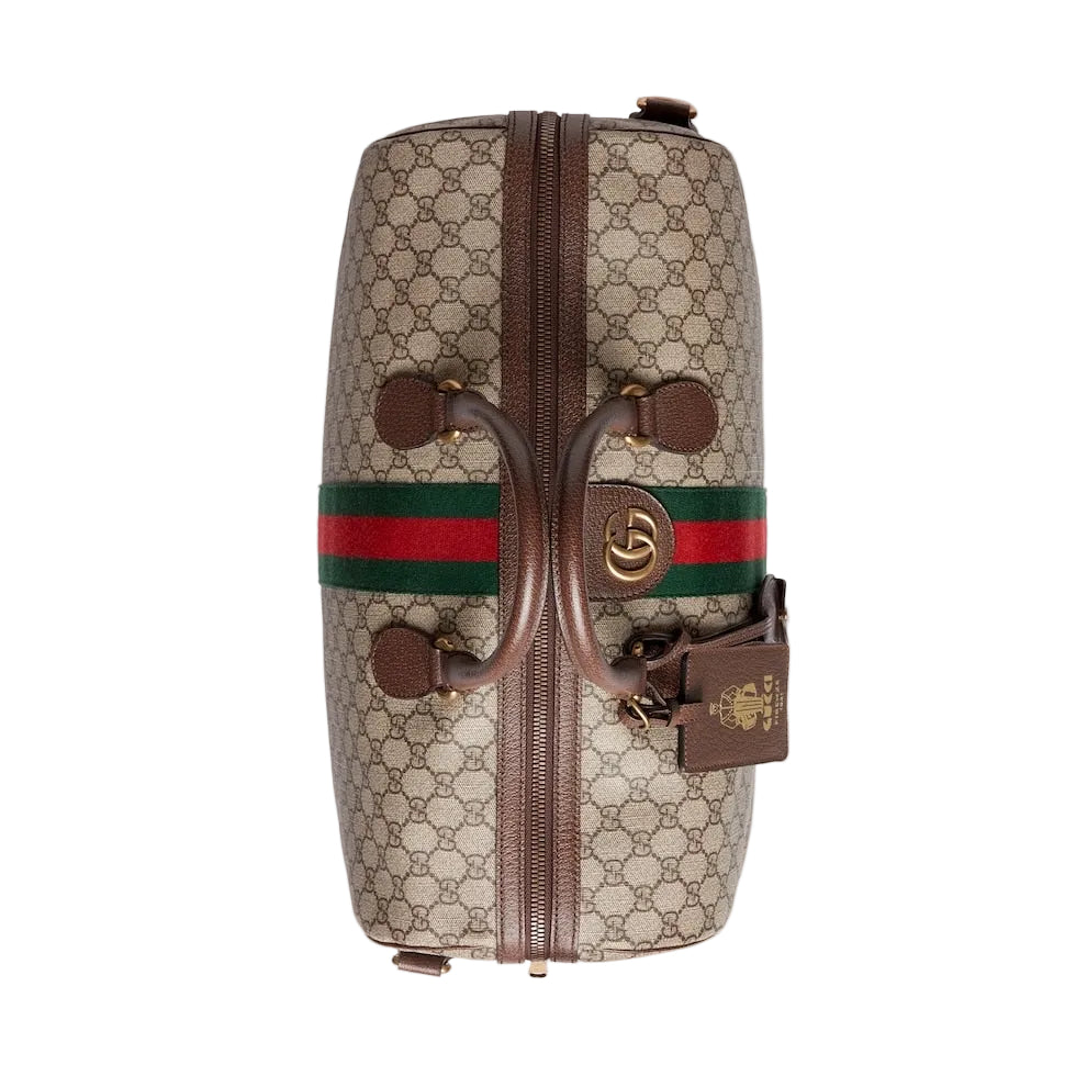 Gucci bag with monogram pattern and iconic green and red stripes on a light gray background