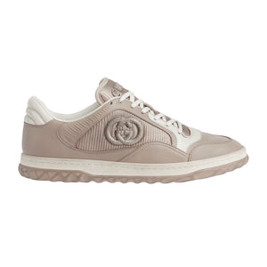 Beige Gucci sneaker with white accents on a white background