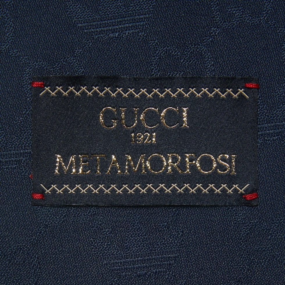 Gucci label on a dark fabric background
