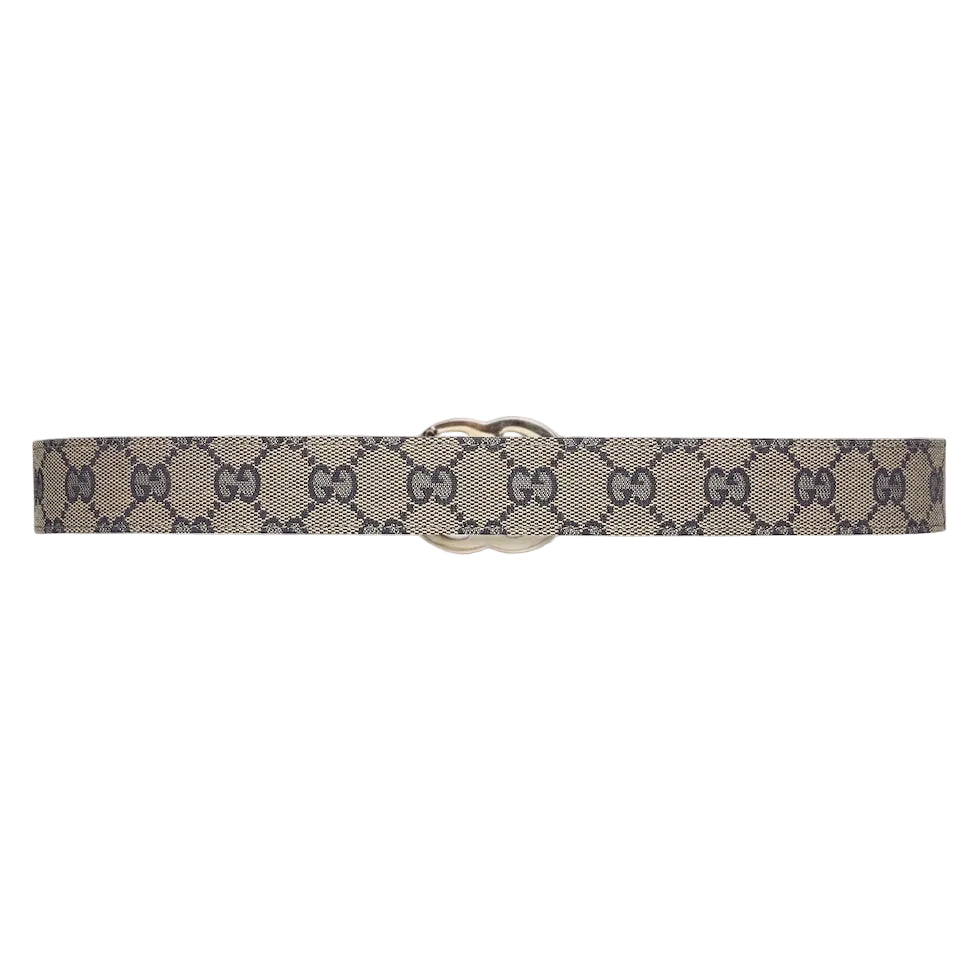 Beige belt with Gucci monogram pattern on a white background