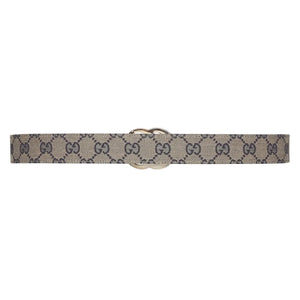 Beige belt with Gucci monogram pattern on a white background