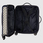 Open black suitcase with patterned interior on a light gray background