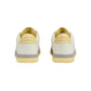 Pair of beige sneakers with gray accents on a light gray background