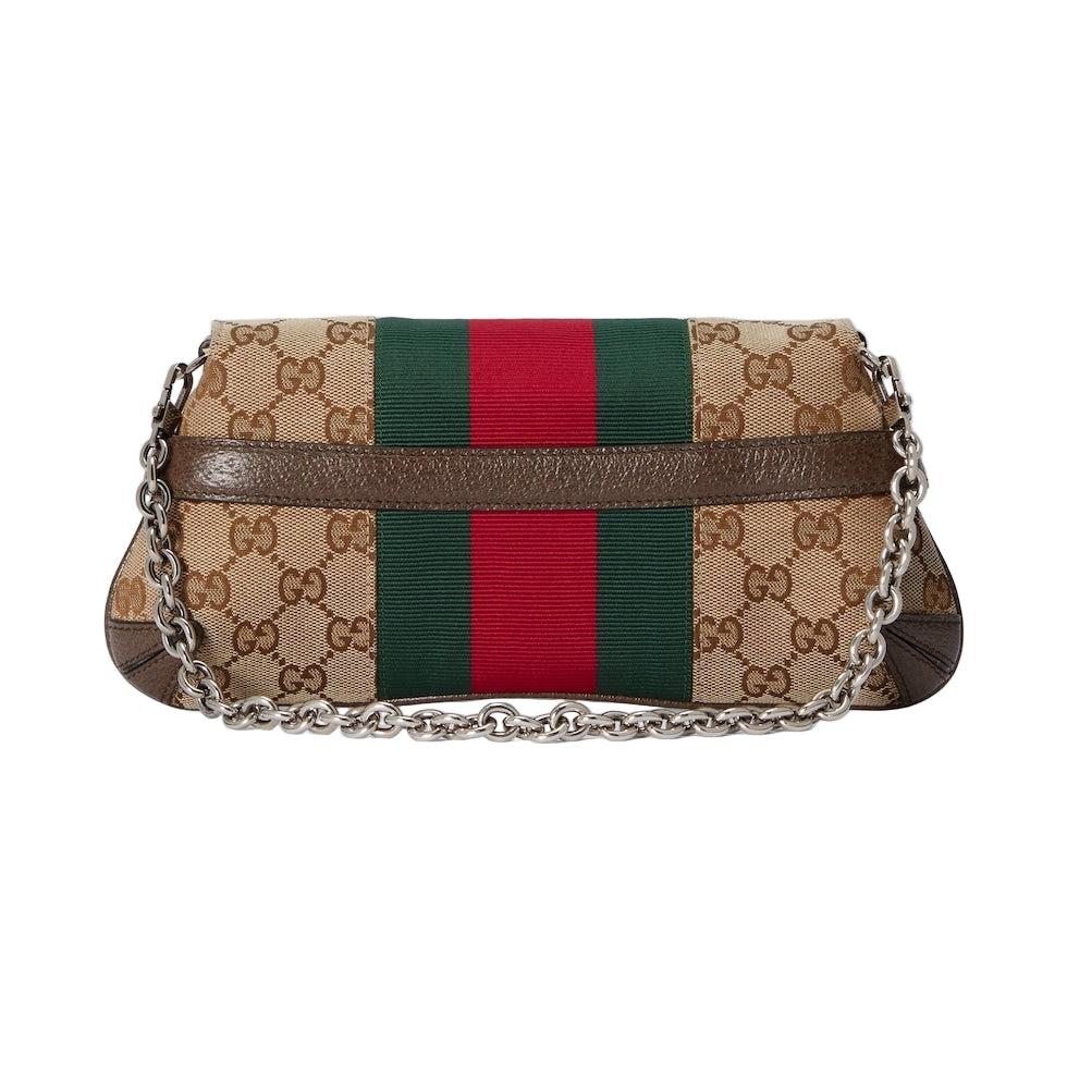 Designer handbag with chain strap on a light gray background