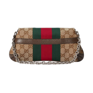 Designer handbag with chain strap on a light gray background