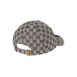 Beige cap with Gucci logo pattern on a light gray background