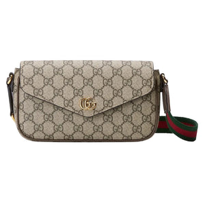 Designer handbag with brand logo on a light gray background
