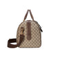 Designer handbag with brown and beige pattern on a light gray background