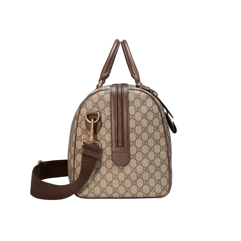 Designer handbag with brown and beige pattern on a light gray background