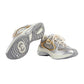 Silver and gold sneakers on a light gray background